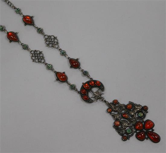 An early 20th century continental silver, enamel and cabochon set drop pendant necklace with flambe and crescent motifs, 57cm.